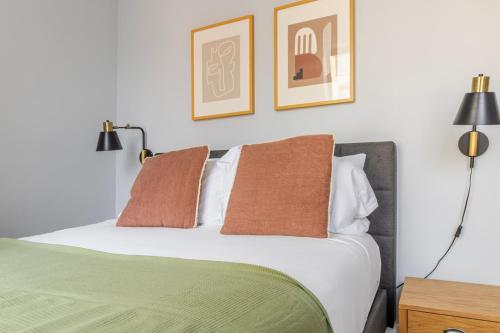 a bedroom with a green and white bed with two pillows at Blueground Midtown West washerdryer nr Central Park NYC-1877 in New York