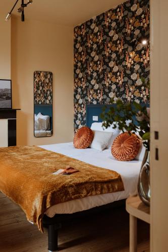 a bedroom with a bed with pillows on it at B&B het Notarishuis - authentiek verblijf nabij Maastricht in Voeren