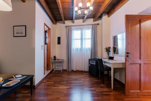 a living room with a desk and a window at Zacosta Villa Hotel in Rhodes Town