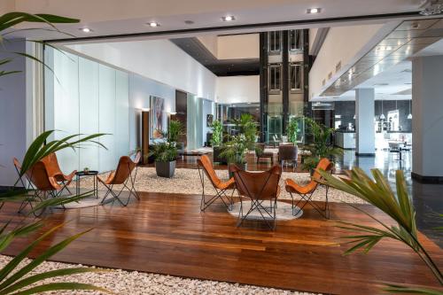 an office lobby with chairs and a table at Hotel Diagonal Plaza in Zaragoza