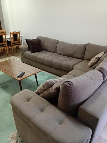 a living room with a couch and a coffee table at Comfort hillside in Pristina