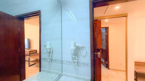 a room with a glass wall next to a door at Aqaba Gulf Hotel By FHM in Aqaba