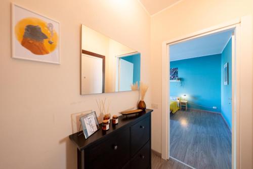 a room with a dresser and two mirrors at Jervis Suite in Ivrea