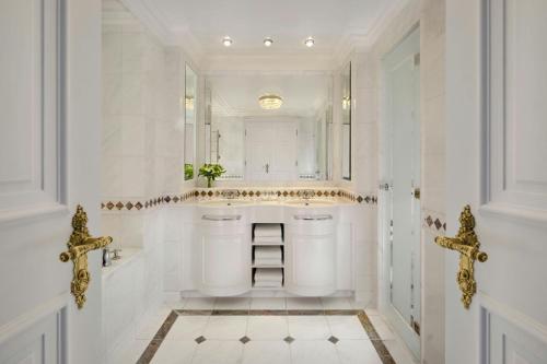 a bathroom with two sinks and a mirror at Powerscourt Hotel, Autograph Collection in Enniskerry