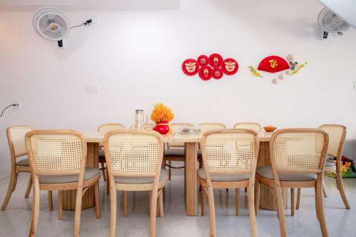 a dining room with a wooden table and chairs at Homestay mon house quy nhơn-phòng in Quy Nhon