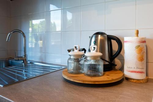 a kitchen counter with a coffee pot on a cutting board at Jervis Suite in Ivrea