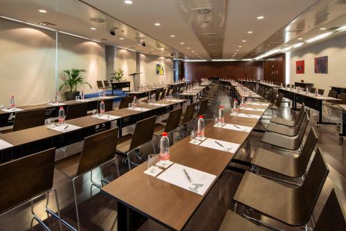 a large dining room with tables and chairs at Hotel Diagonal Plaza in Zaragoza