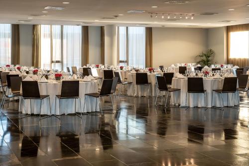 a large banquet hall with tables and chairs at Hotel Diagonal Plaza in Zaragoza
