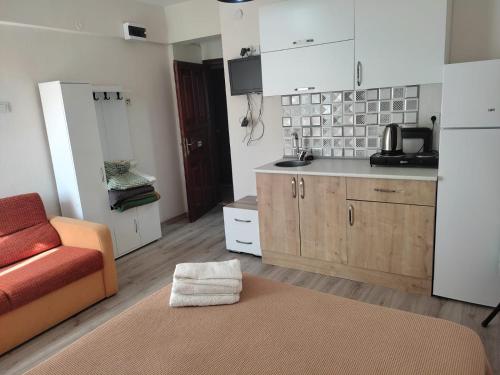 a living room with a couch and a kitchen at Garden Prizma Apart in Kemer