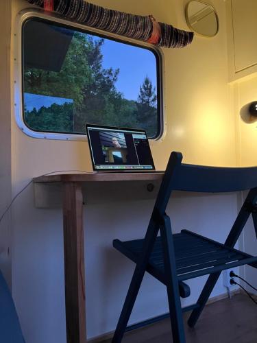 a laptop sitting on a desk in a train at Villa Lugina in Fushë-Buall