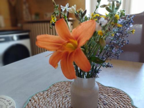 a vase filled with flowers on a table at L'étoile du matin in Terville