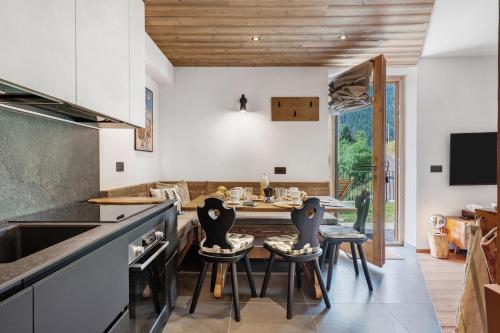 a kitchen with a table and chairs and a dining room at La Casa di Larice in Val di Sole in Rabbi