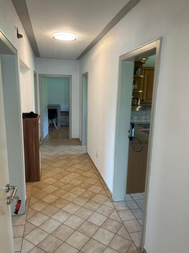 an empty hallway of a house with a tile floor at Monteurzimmer oder WG Zimmervermietung in traumhafter Lage in Laufenburg