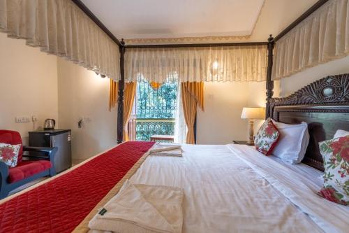 a bedroom with a large bed and a window at Palm Grove Cottages - Leisure Resort in Benaulim