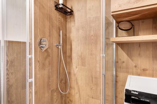 a shower with a glass door in a bathroom at La Casa di Larice in Val di Sole in Rabbi