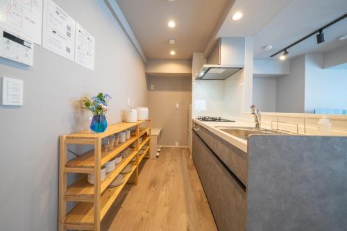 a kitchen with a sink and a counter top at Starry Stay Suite Improve Nishimagome in Tokyo