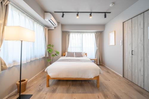 a bedroom with a bed and a window at Starry Stay Suite Improve Nishimagome in Tokyo