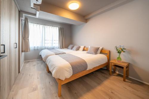 a bedroom with a large bed and a window at Starry Stay Suite Improve Nishimagome in Tokyo