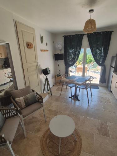 a living room with a couch and a table at Gites Colline De Sollies in Salernes
