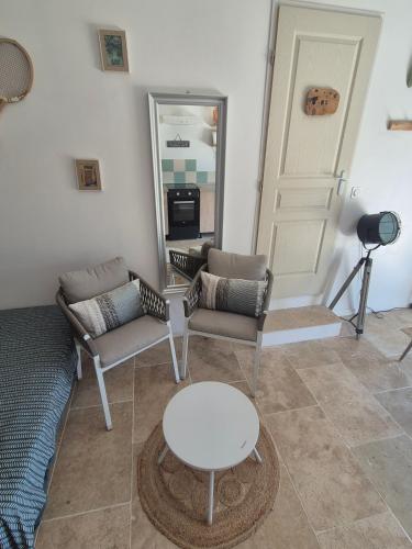 a living room with a couch and a table and a mirror at Gites Colline De Sollies in Salernes