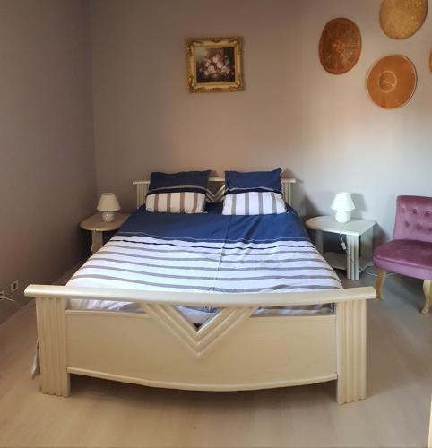 une chambre avec un grand lit avec des draps bleus et blancs dans l'établissement T2 très belle vue bassin avec balcon 100 m plage, à Arcachon