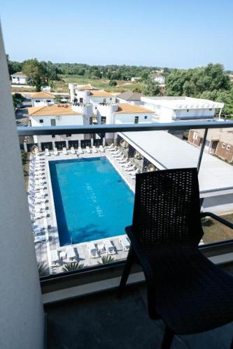 a balcony with a chair and a swimming pool at M&N Holiday Resort in Ulcinj