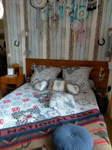 a bedroom with a bed with a blue umbrella on it at Jadis sous la gloriette in Sancoins