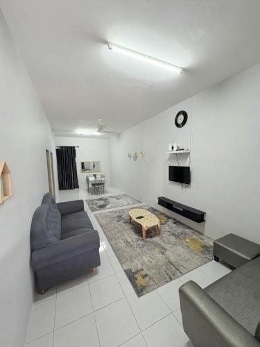 a living room with a couch and a table at Al Marwa Homestay Jerantut in Jerantut