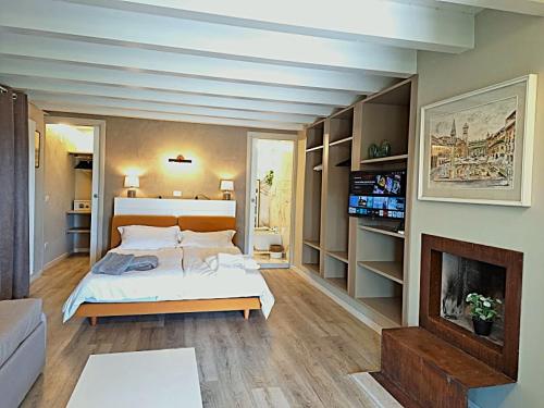 a large bedroom with a bed and a fireplace at Villa dell'Olivo Bianco in Castion Veronese