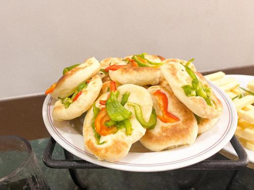 a plate of sandwiches on a table with fries at Aqaba Gulf Hotel By FHM in Aqaba