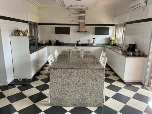 a kitchen with a granite counter top in a room at Oasis luxueuse en bord de Mer Virage Dakar in Dakar