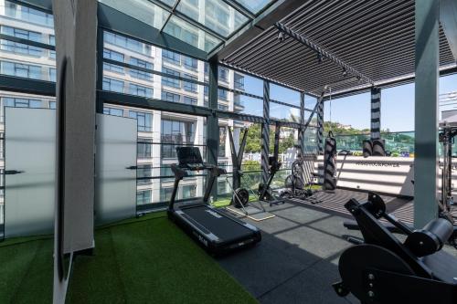an office with a gym with exercise equipment and windows at Rusel Park Residence in Bahcesehir