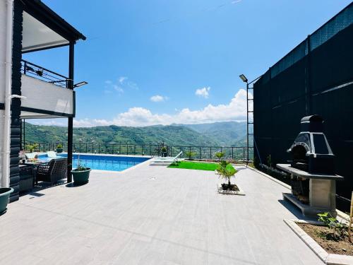 a patio with a view of the mountains at Lemongarden in Akcaabat