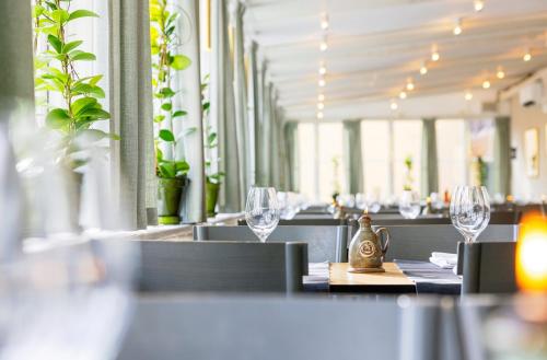 a row of wine glasses on a table in a restaurant at Långholmen Hotell in Stockholm