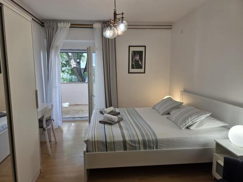 Postel nebo postele na pokoji v ubytování Apartmani Eta