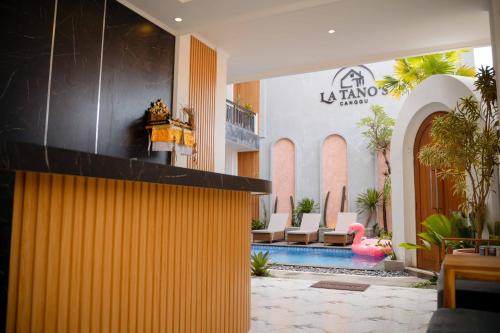 a lobby with a swimming pool in a building at La Tano's Canggu in Canggu