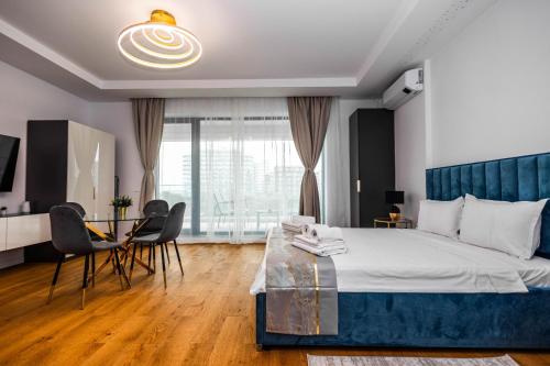 ein Schlafzimmer mit einem Bett, einem Tisch und Stühlen in der Unterkunft Lilly Studio Axxis Beach in Mamaia
