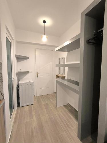 a room with a hallway with a white door and shelves at MD Luxury Studios in Himare