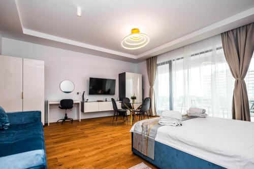 a bedroom with a bed and a table and chairs at Lilly Studio Axxis Beach in Mamaia