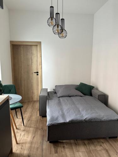 a bedroom with a bed and a table and a door at Apartment lilly in Poprad