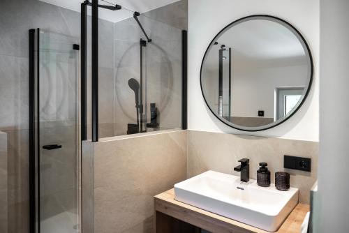 a bathroom with a sink and a mirror at Gasthof Schöntal in Werfenweng