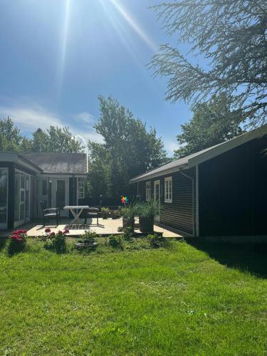 a yard with a house and a picnic table at Holiday Home At Fynshoved in Martofte