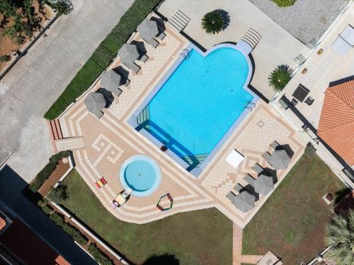 an overhead view of a swimming pool with a heart shaped pool at Lofos Panorama Apartments in Prínos