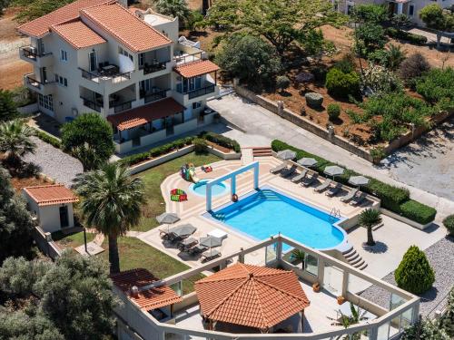 an aerial view of a house with a swimming pool at Lofos Panorama Apartments in Prínos