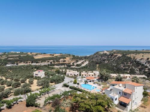 an aerial view of a house and the ocean at Lofos Panorama Apartments in Prínos