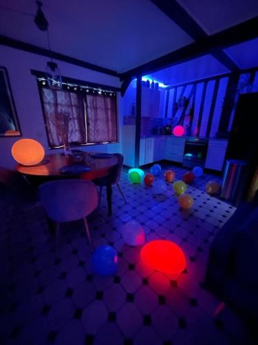 a living room with a table and balls on the floor at La Chaumière aux Animaux in Touffreville-la-Corbeline