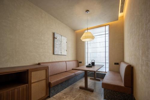 a living room with a couch and a table at Atour Hotel Wenzhou Wuma Street Pedestrian Street in Wenzhou