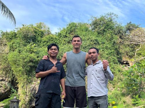 a group of three men standing next to each other at Cersen Resort Lombok in Kuta Lombok