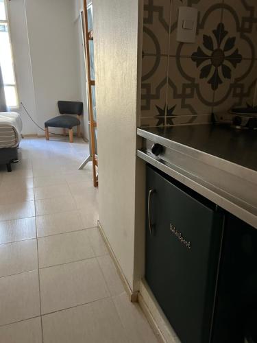 a kitchen with a dishwasher in a room at Maipu Apartment Studio in Buenos Aires