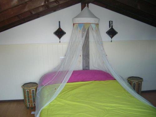 a bed with a canopy in a room at Casa Escondida in Albuñuelas
